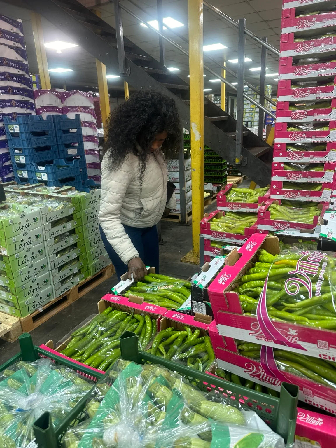 Doris Beth Atigo examining the fresh produce on display at Spitalfields Market.