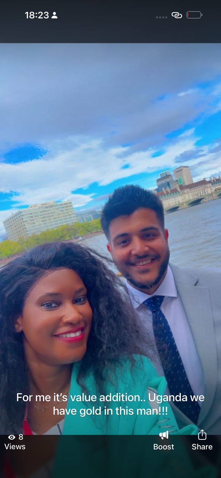 Doris beside a fellow participant in a grey suit in London.