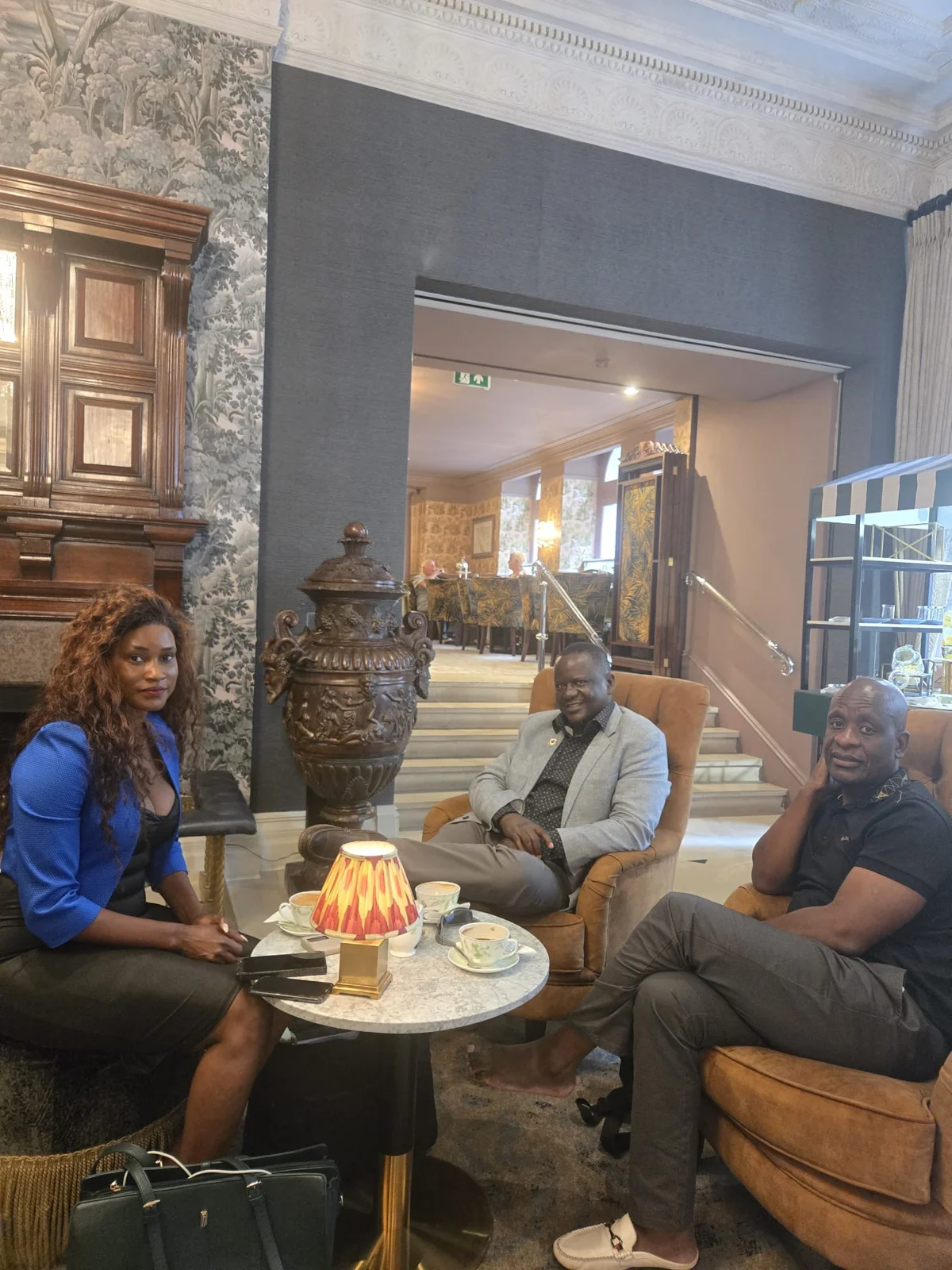 Doris Beth Atigo seated around a table with two fellow participants.